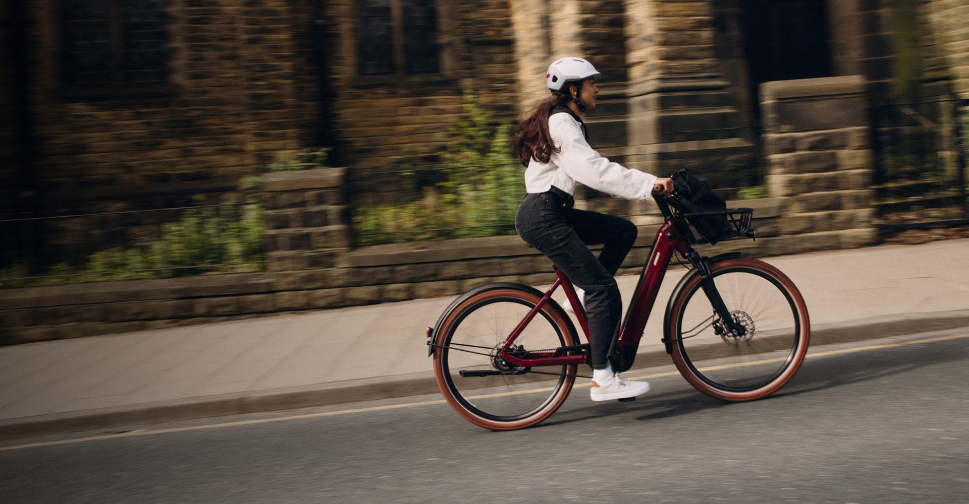 Woman riding Flourish E+ 1 on pavement.