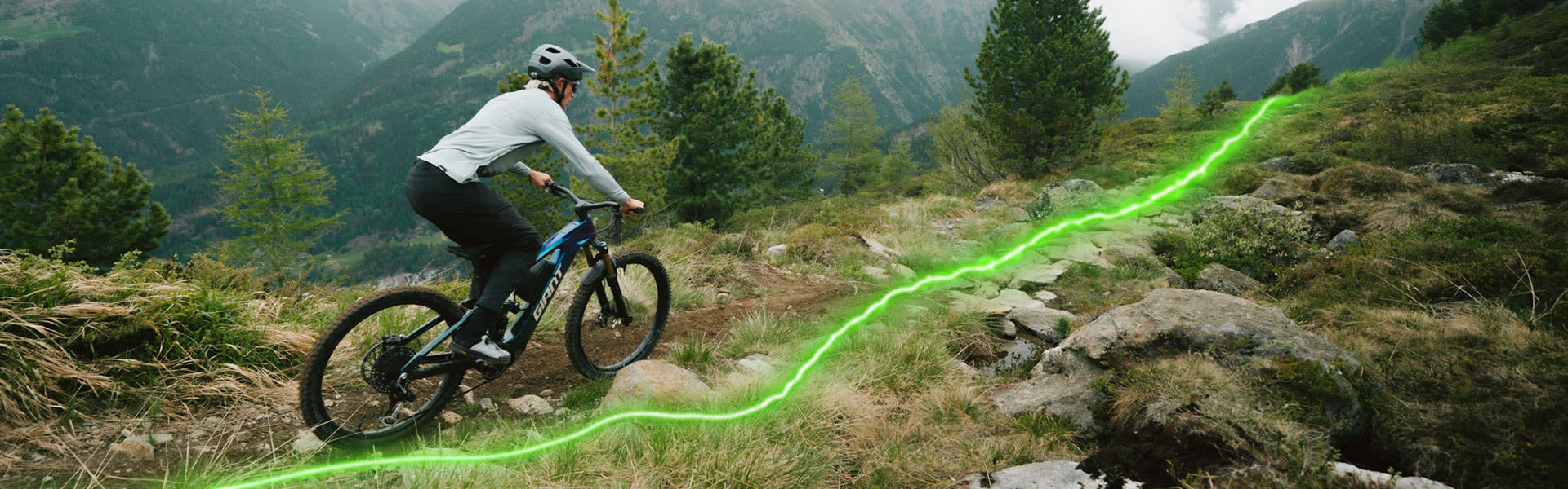 Mountain biker riding up a rocky trail