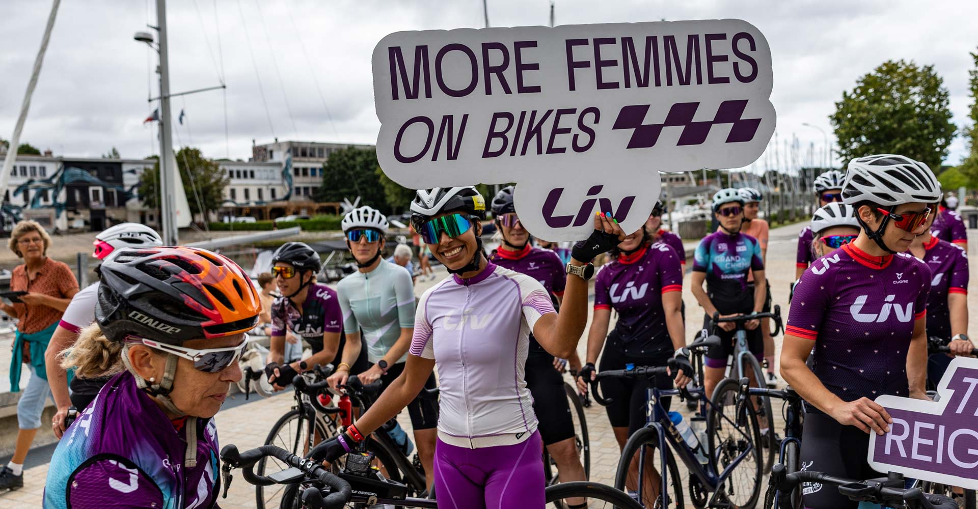 Liv Racing Team Holding up sign