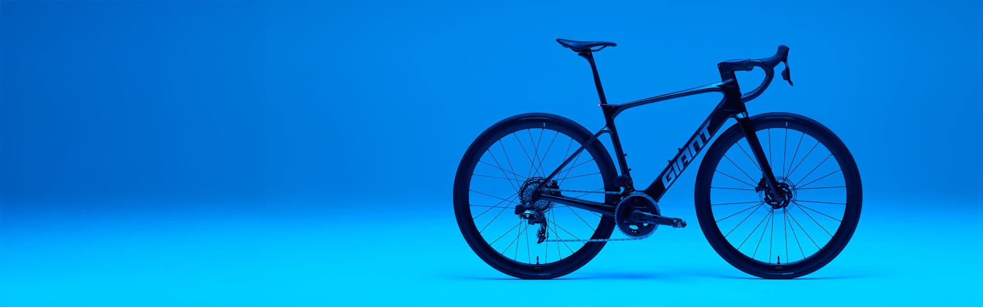 defy e+ advanced electric road bike on blue background