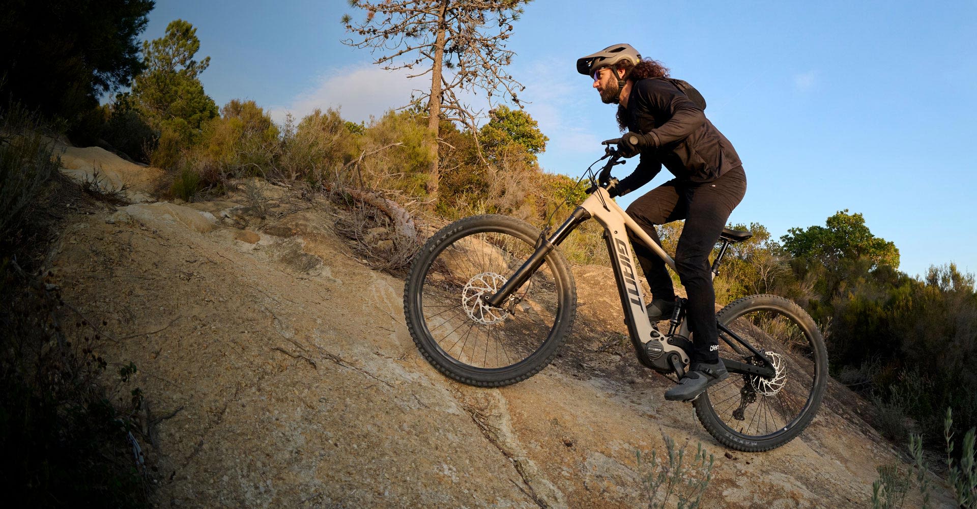 mountain biker riding up rocky trail