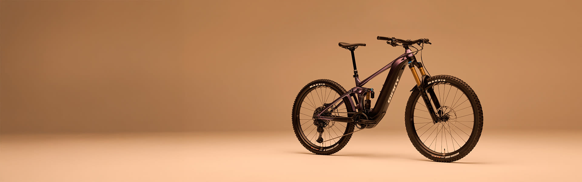 Reign E+ electric mountain bike on colored background