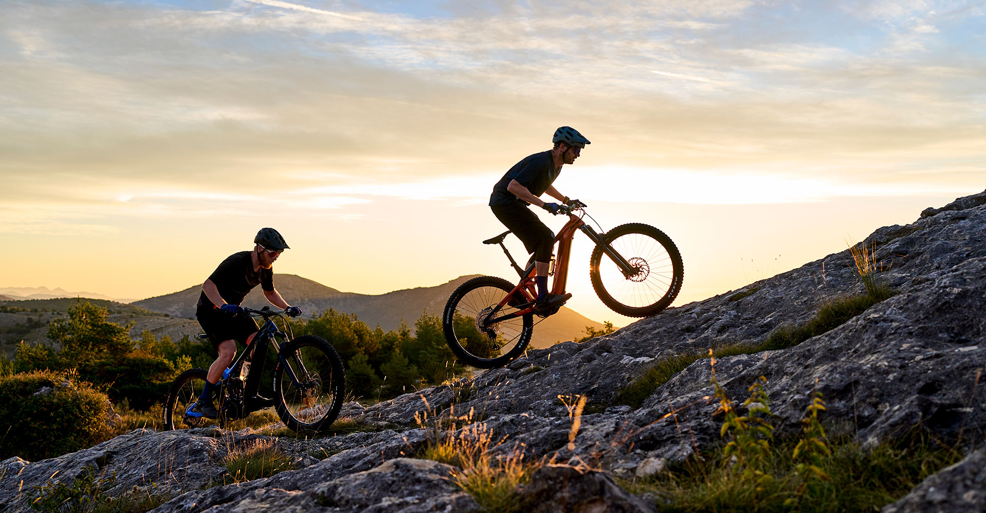 Ebikers climbing in sunset