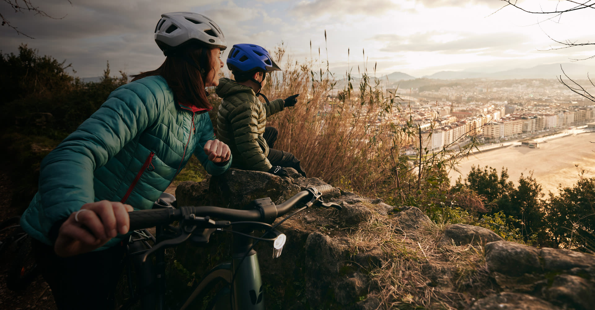 a woman with her son on bikes at an overlook