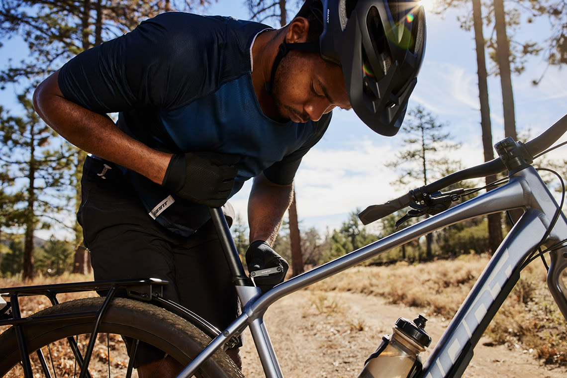 image of man adjusting the seatpost on his Giant bicycle